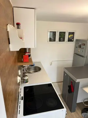 a small kitchen with a stove and a sink at Kutak in Podgorica