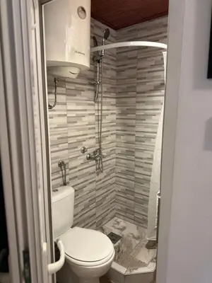 a bathroom with a toilet and a shower at Kutak in Podgorica