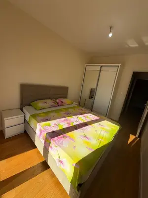 a bedroom with a bed with a colorful comforter at Oaza Bar 1 in Bar