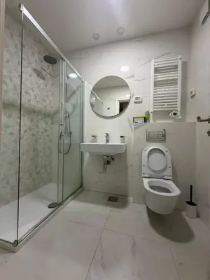 a bathroom with a shower and a toilet and a sink at Oaza Bar 1 in Bar