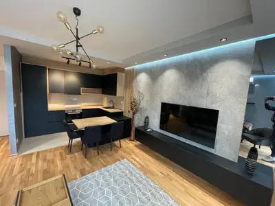 a living room with a dining table and a fireplace at Montenegro Black Suite in Podgorica