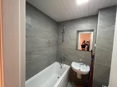 a bathroom with a sink and a tub and a toilet at Montenegro Black Suite in Podgorica
