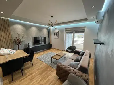 a living room with a couch and a table at Montenegro Black Suite in Podgorica