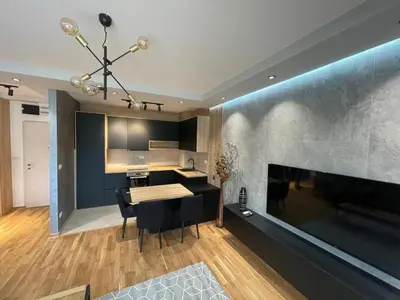a kitchen with a table and a dining room at Montenegro Black Suite in Podgorica
