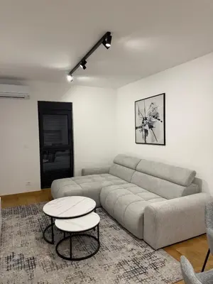 a living room with a couch and a table at Montenegro White Suite in Podgorica