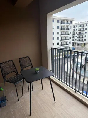 a table and two chairs on a balcony with a view at Montenegro White Suite in Podgorica