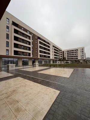 a large building with a courtyard in front of it at Montenegro White Suite in Podgorica