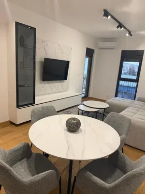 a living room with a white table and chairs at Montenegro White Suite in Podgorica