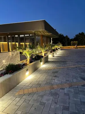 a building with a lot of plants in front of it at Bilali Apartments in Ulcinj