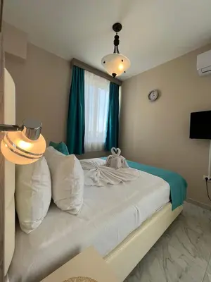 a bedroom with a bed with a teddy bear on it at Bilali Apartments in Ulcinj