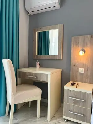 a desk with a mirror and a chair in a room at Bilali Apartments in Ulcinj