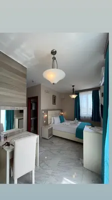 a large bedroom with a bed and a table and chairs at Bilali Apartments in Ulcinj