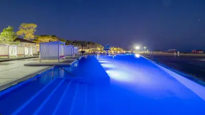 a swimming pool with blue lighting at night at Azul Beach Resort Montenegro by Karisma - All Inclusive in Ulcinj