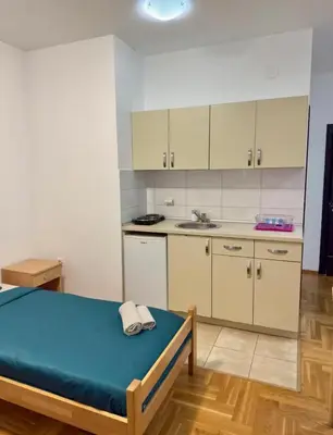 a small kitchen with a bed in a room at ADAIST Apartments Budva Free Parking & Balcony in Budva