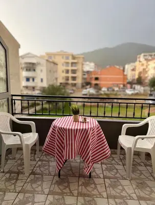 a table and chairs on a balcony with a view at ADAIST Apartments Budva Free Parking & Balcony in Budva