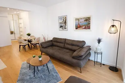 a living room with a couch and a table at Olive apartments in Petrovac na Moru