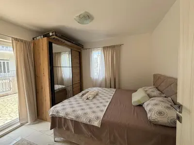 a bedroom with a bed and a large window at Radon apartments in Dobra Voda