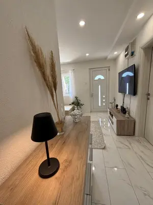 a living room with a lamp and a television at Radon apartments in Dobra Voda