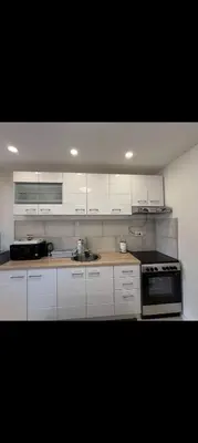 a kitchen with white cabinets and a stove at Radon apartments in Dobra Voda