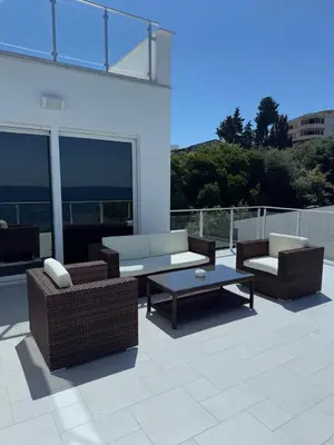 a patio with two couches and a coffee table at Sea Whisper Villa in Dobra Voda