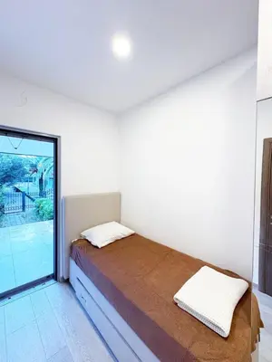 a bedroom with a bed and a large window at Flat in Budva with terrace and private garden in Budva