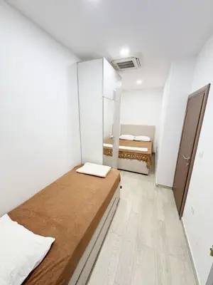 a small bedroom with two beds and a closet at Flat in Budva with terrace and private garden in Budva