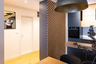a kitchen with a dining table and a wall at Tramonto City Center Apt with Sea View and Garage in Bar
