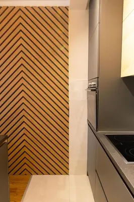 a kitchen with a wooden accent wall and a refrigerator at Tramonto City Center Apt with Sea View and Garage in Bar