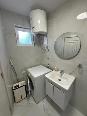 a white bathroom with a sink and a mirror at Ani Sea Lux in Dobra Voda