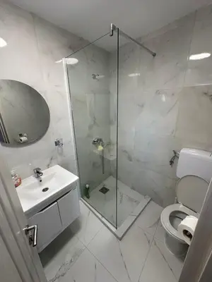 a bathroom with a shower and a sink and a toilet at Ani Sea Lux in Dobra Voda