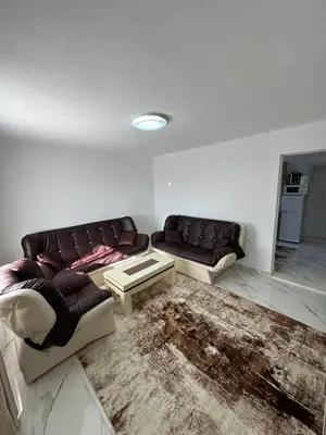 a living room with two couches and a table at Ani Sea Lux in Dobra Voda