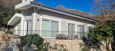 a house with a balcony with chairs on it at Sunrise Villa in Bar