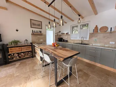 a large kitchen with a wooden table and chairs at Sunrise Villa in Bar