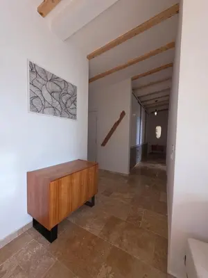 a hallway with a wooden bench and a painting on a wall at Sunrise Villa in Bar