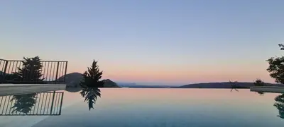 a swimming pool with a sunset in the background at Sunrise Villa in Bar