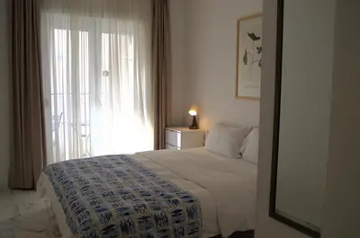 a bedroom with a bed and a large window at Yeshill Deluxe Apartment in Budva
