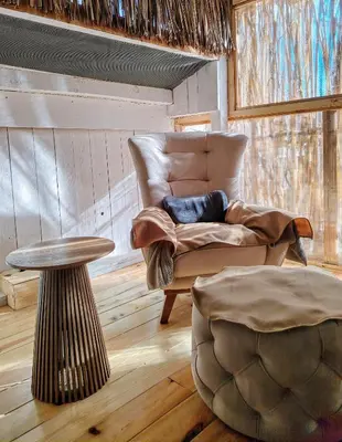 a living room with a chair and a table at Hedonizam Lux in Podgorica