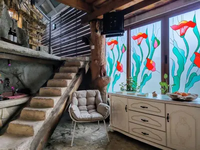 a room with a staircase and a window with a fish mural at Hedonizam Lux in Podgorica