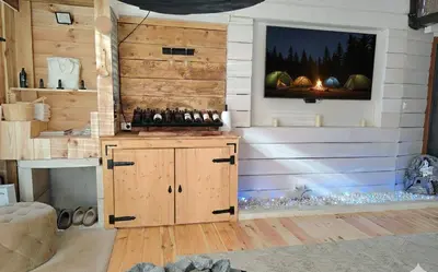 a room with a wooden wall with a tv on it at Hedonizam Lux in Podgorica