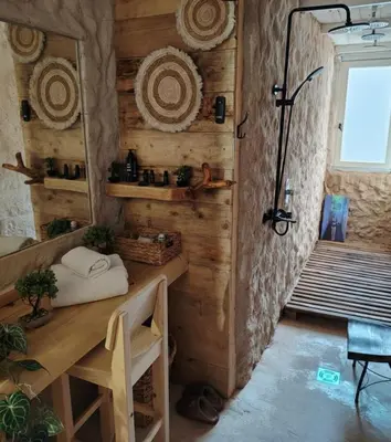 a room with a wooden wall with a desk and a mirror at Hedonizam Lux in Podgorica