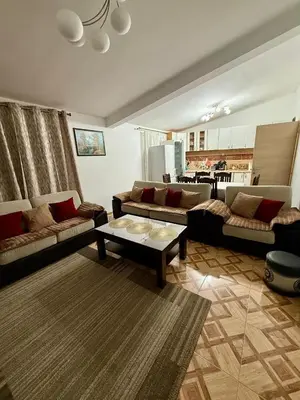a living room with two couches and a table at Sutomore 3-bedroom apartment in Sutomore