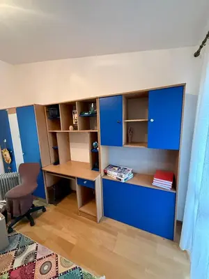 a room with blue cabinets and a desk and a desk gmaxwell gmaxwell gmaxwellythonython at Sutomore 3-bedroom apartment in Sutomore