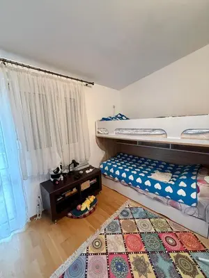 a bedroom with two bunk beds and a rug at Sutomore 3-bedroom apartment in Sutomore