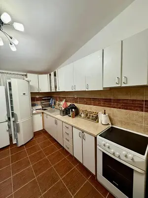 a kitchen with white cabinets and white appliances at Sutomore 3-bedroom apartment in Sutomore