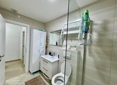a bathroom with a toilet and a sink and a shower at Bar Lux Two-Bedroom apartment in Bar