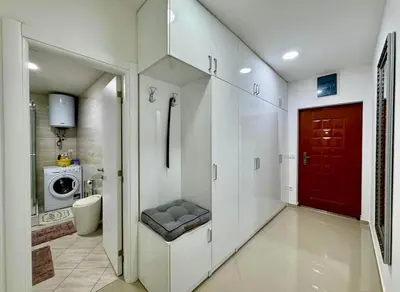 a bathroom with a washing machine and a red door at Bar Lux Two-Bedroom apartment in Bar