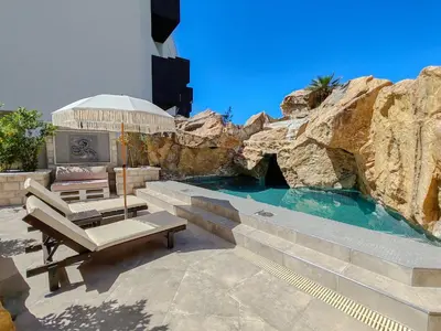 a patio with a bench and a swimming pool at Serenity Apartment in Becici