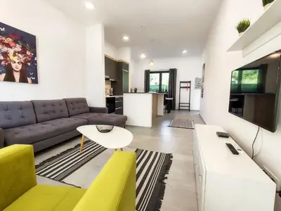 a living room with a couch and a table at Serenity Apartment in Becici