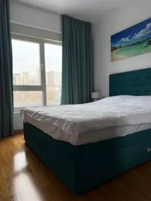 a bedroom with a large bed with a window at Status Complex in Becici