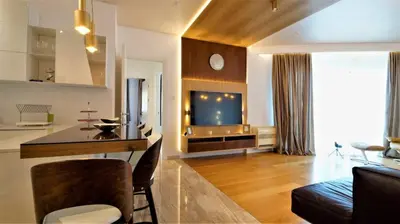 a living room with a kitchen and a living room with a couch at Vista Deluxe apartment - Tre Canne Budva in Budva